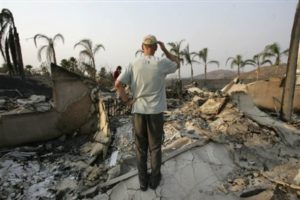 Mark Wery looks on after returning home for the first time Thursday, Oct. 25, 2007, in Poway, Calif. Evacuees were being allowed back into their neighborhoods, and shelters were beginning to empty at an increasingly rapid rate. (AP Photo/Rick Bowmer)